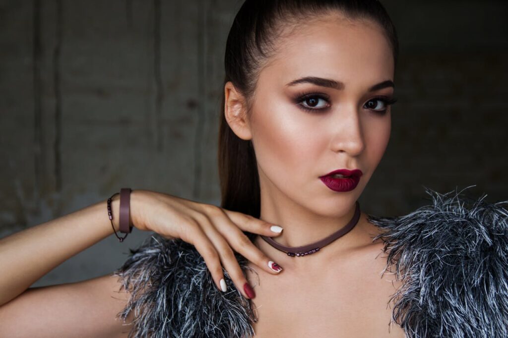 pexels-photo-247287 Close-up portrait of an elegant woman with bold makeup and fashionable attire, exuding confidence.